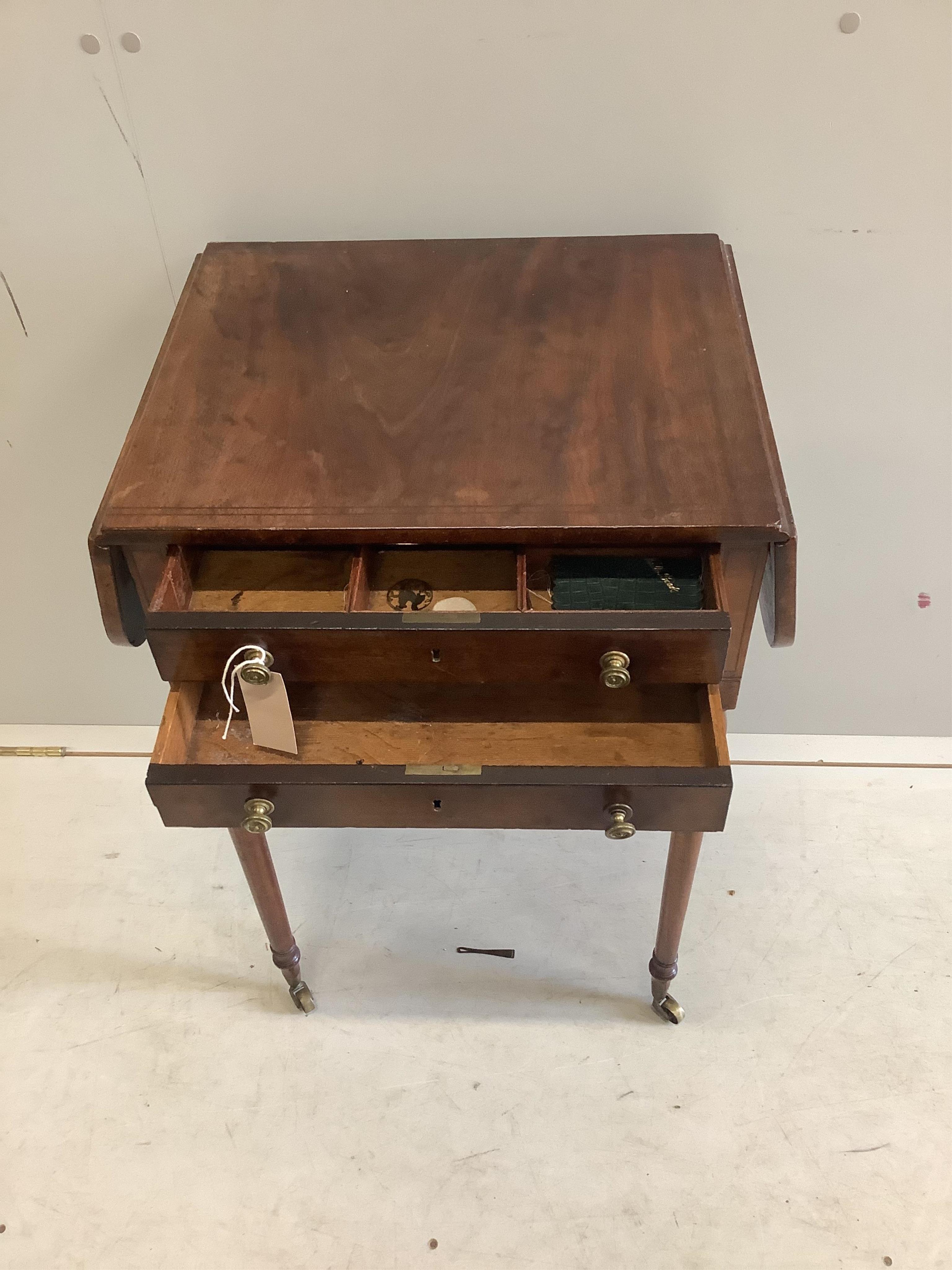 A late Georgian inlaid mahogany sewing table having twin flaps and two drawers on slender turned tapering legs on brass castors, width 47cm, depth 38cm, height 74cm. Condition - fair